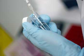 Test tube and pipette in hands - leukaemia research